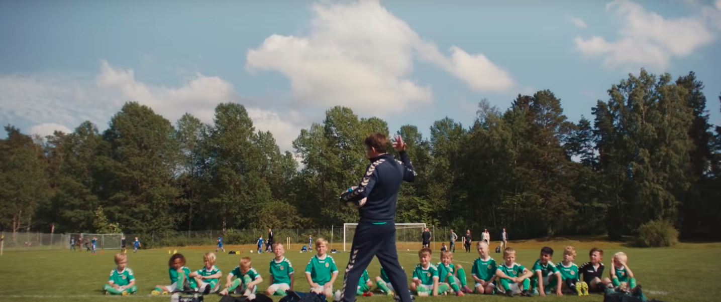 Thomas Bo Larsen gesturing for the boys' soccer team he coaches to stand in "Another Round"