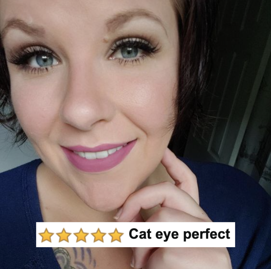 A reviewer photo wearing black liquid eyeliner with five-star caption &quot;cat eye perfect&quot;