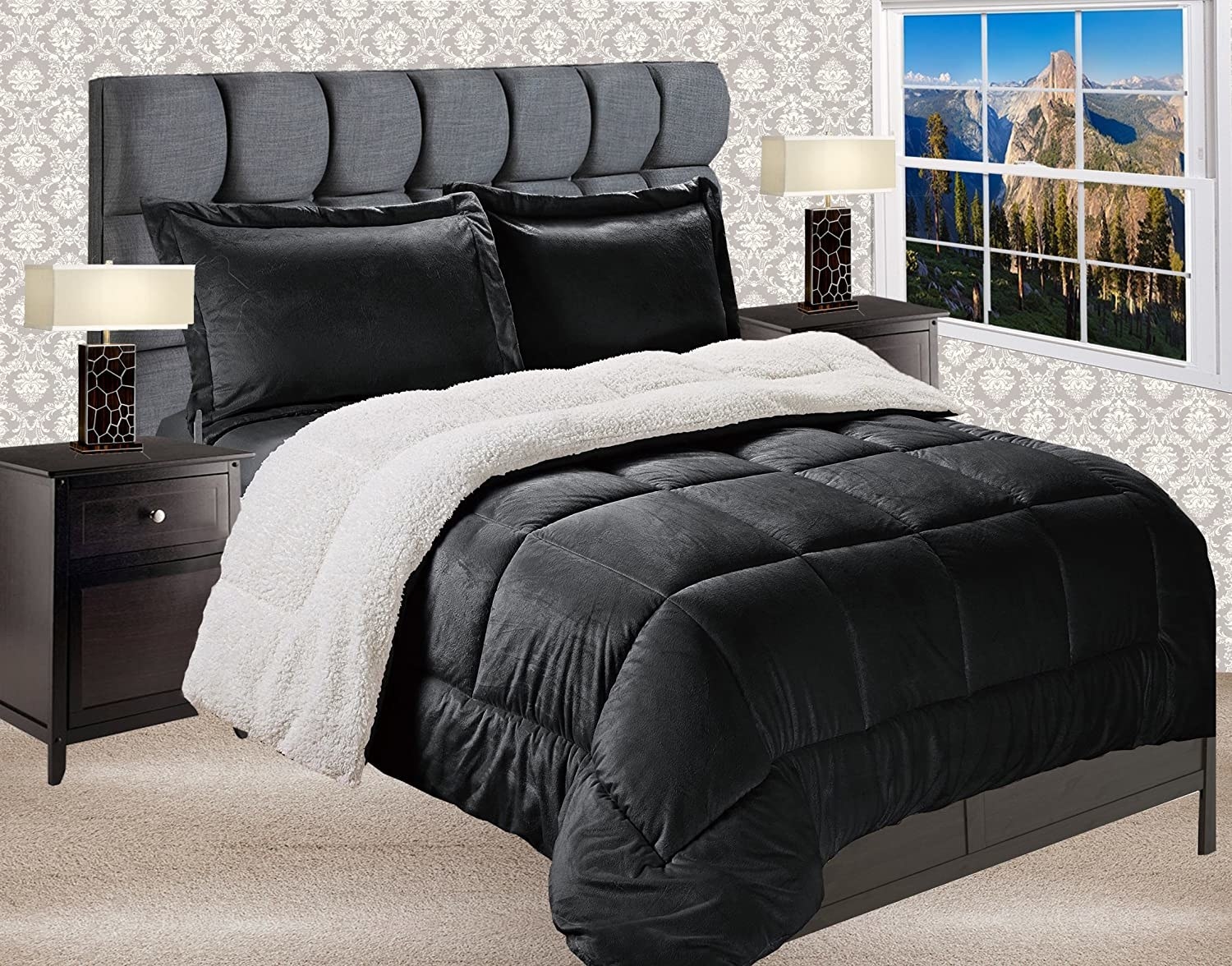 black comforter with fluffy white underside and black pillows on grey bed frame