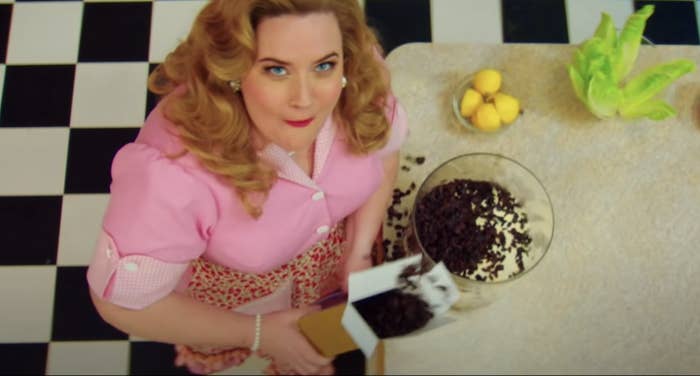 Aidy Brant in a &#x27;50s housewife outfit pouring chocolate chips in a bowl on &quot;SNL&quot;