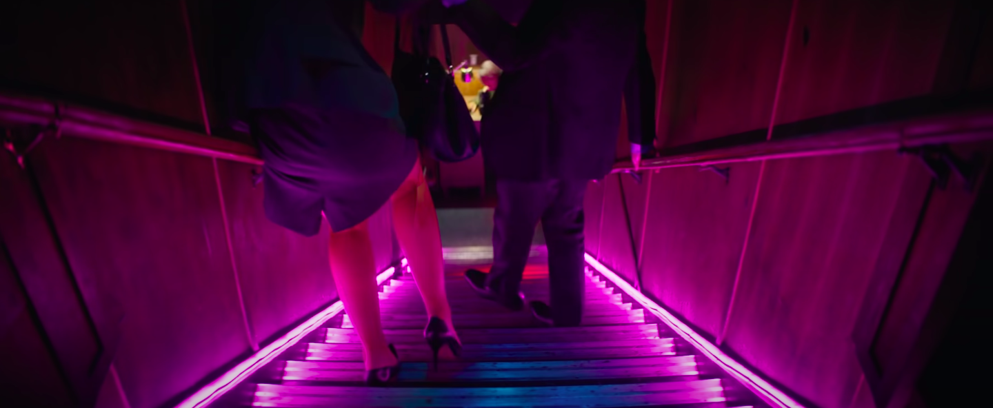 Carey Mulligan and Adam Brody's legs as they walk down the stairs in "Promising Young Woman"
