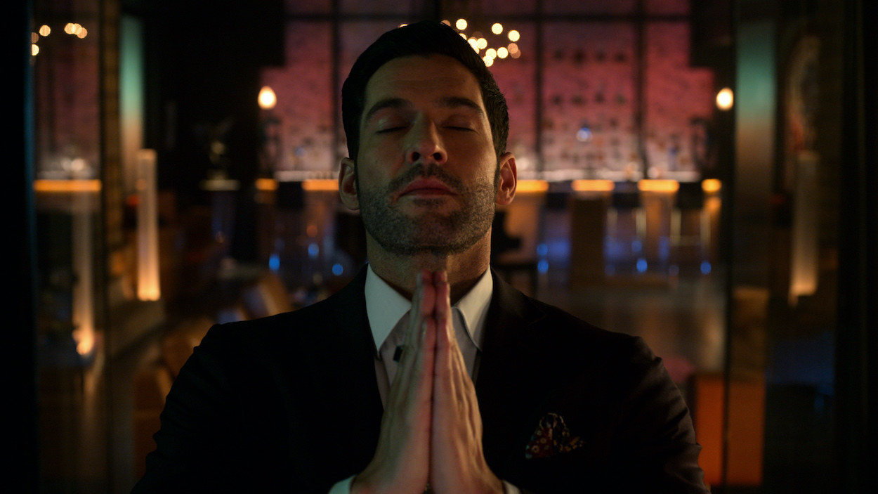 Lucifer with his hands together as if to pray