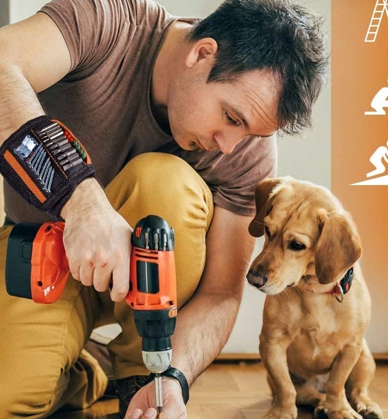 model wearing the band with screws and bits sticking to it as he holds a drill