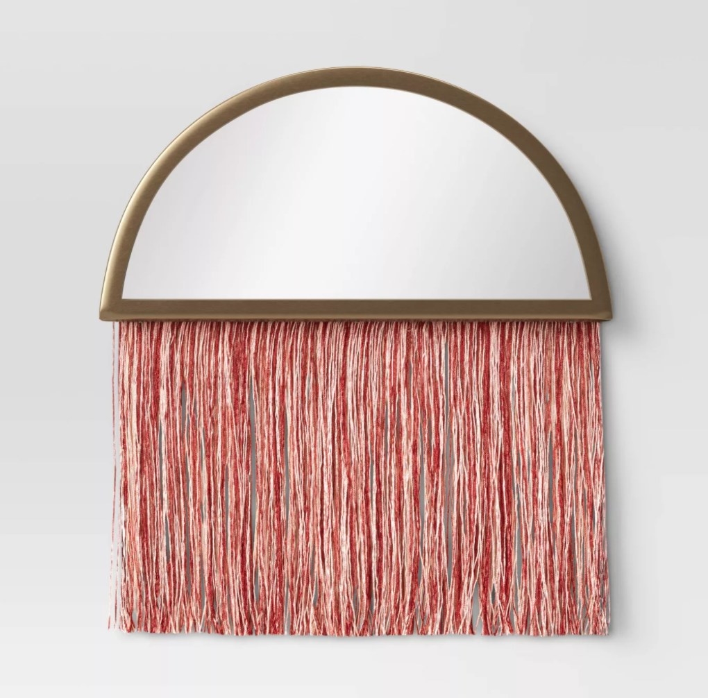 The macrame mirror on the wall