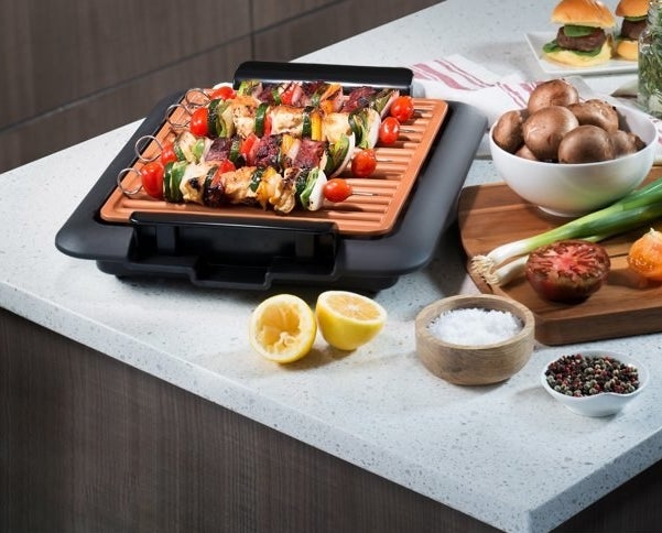 The electric grill, which is small enough to sit on a kitchen counter and has an open grill area with no cover