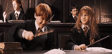 Ron and Hermione practicing spells