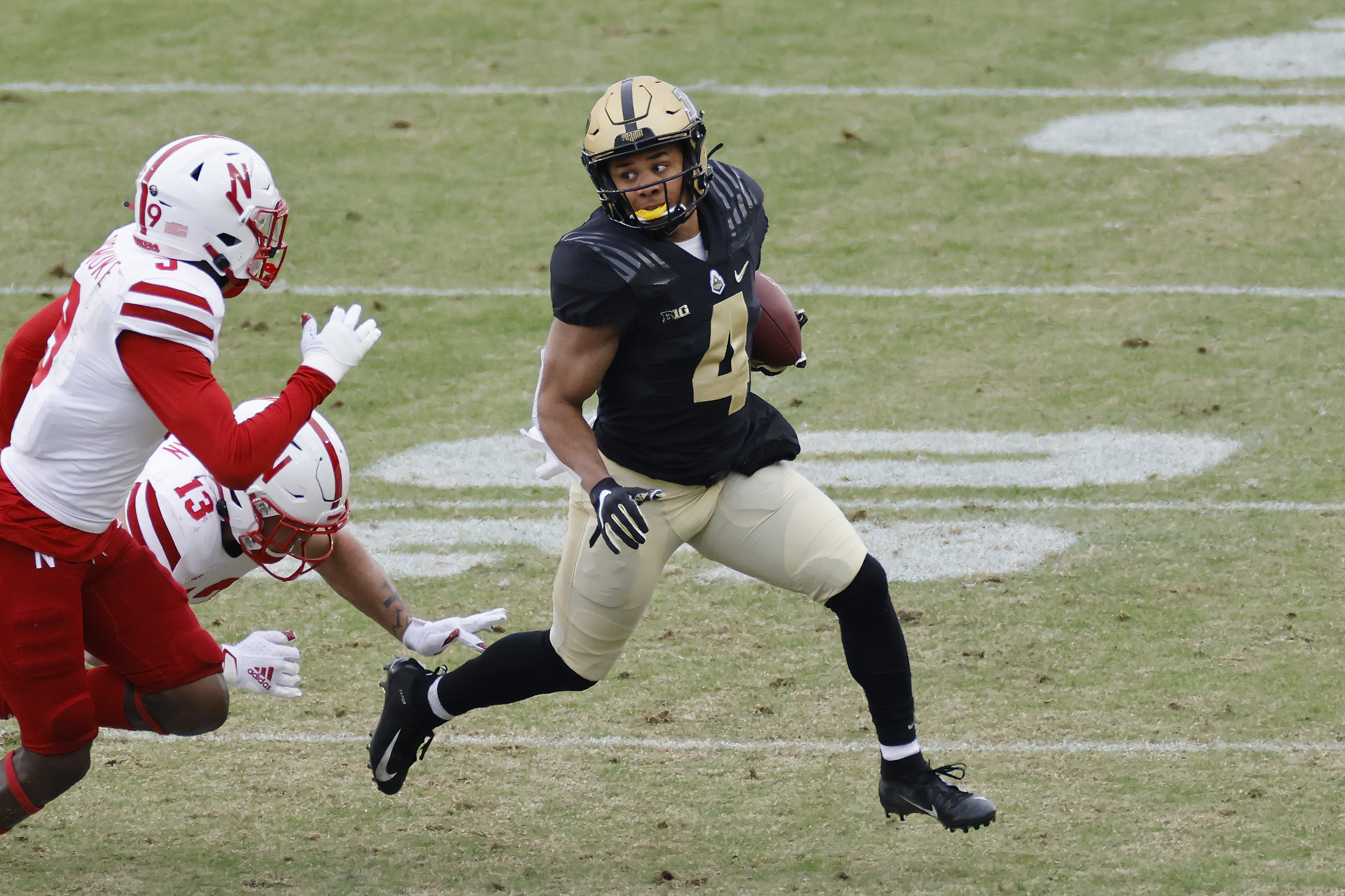 Rondale Moore running away from tacklers