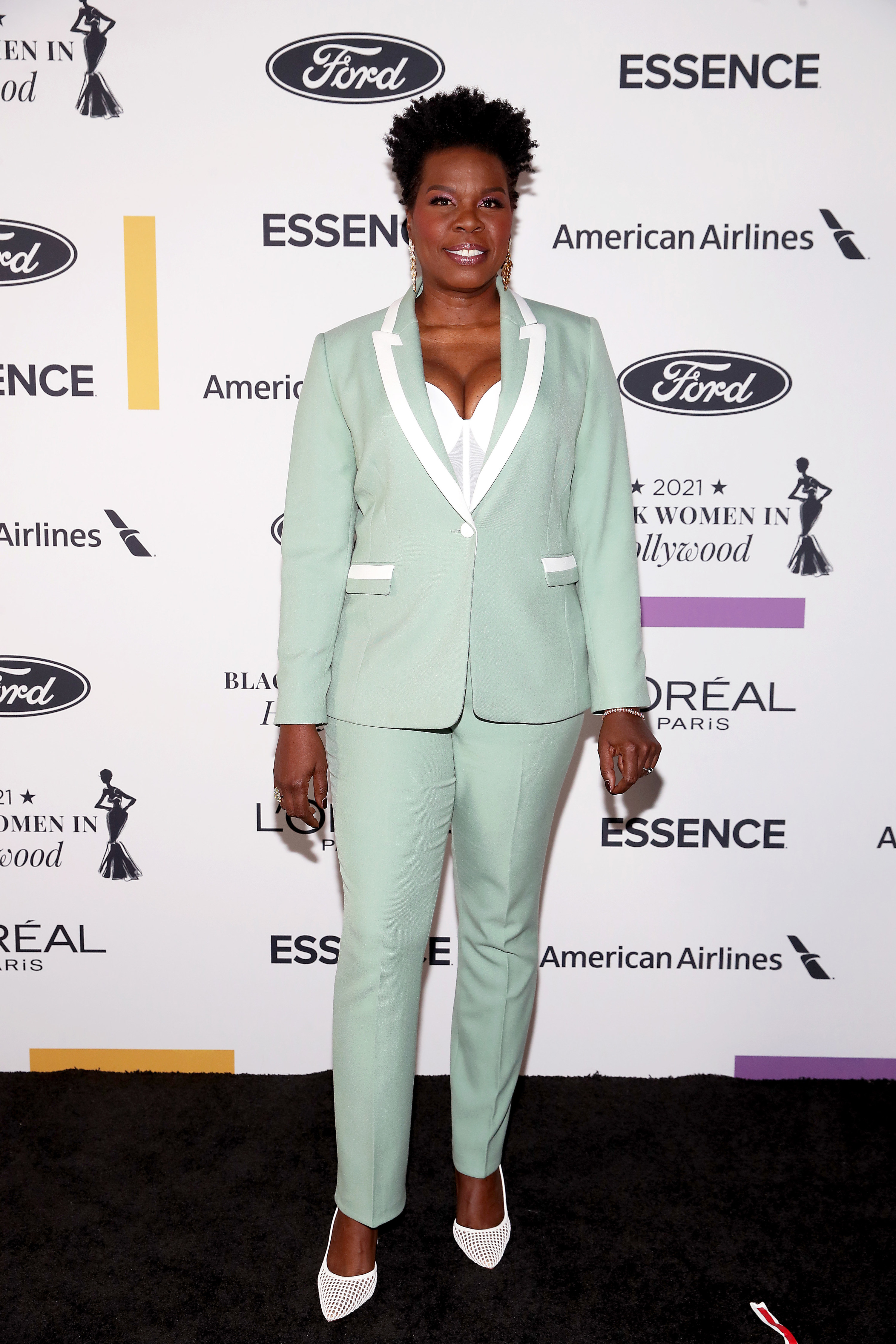 Leslie wears a Tiffany blue suit with white piping details