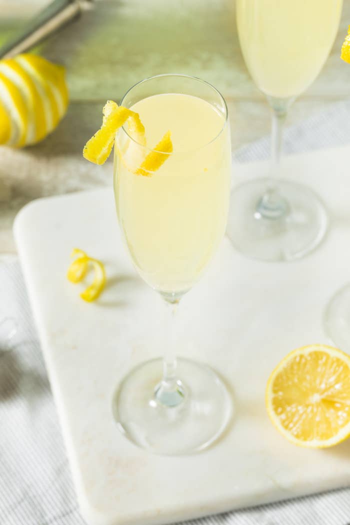 French75 cocktails in Champagne flutes with lemon.