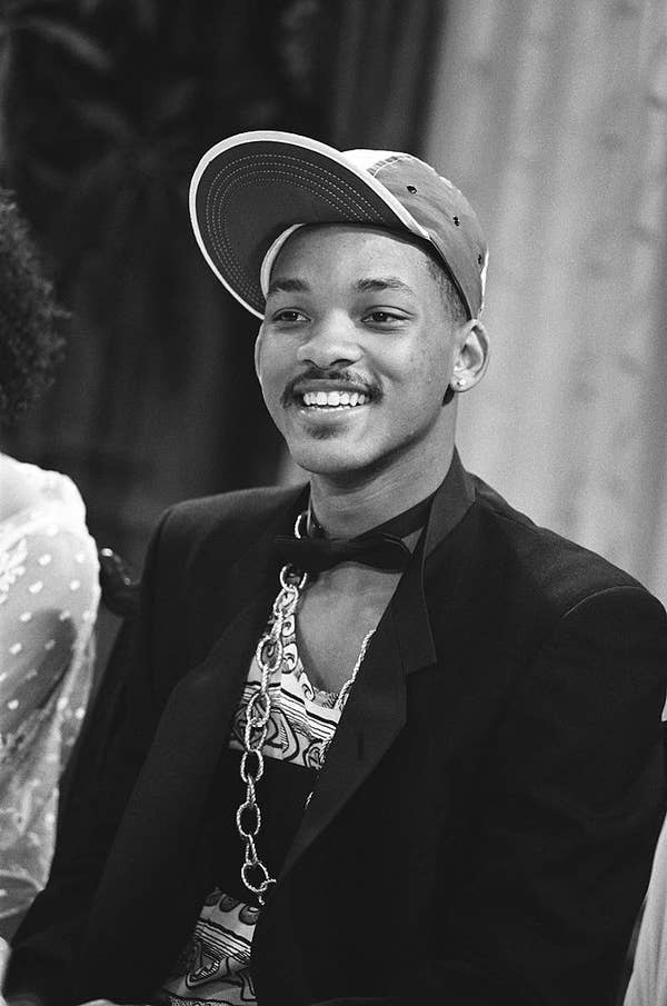 WS wearing a chain and a blazer and a 90s hat