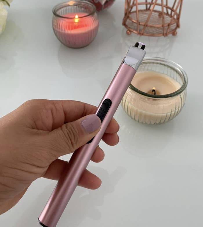 A person holding an electric lighter