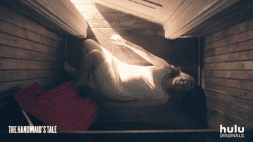 GIF of June lying on the floor alone 
