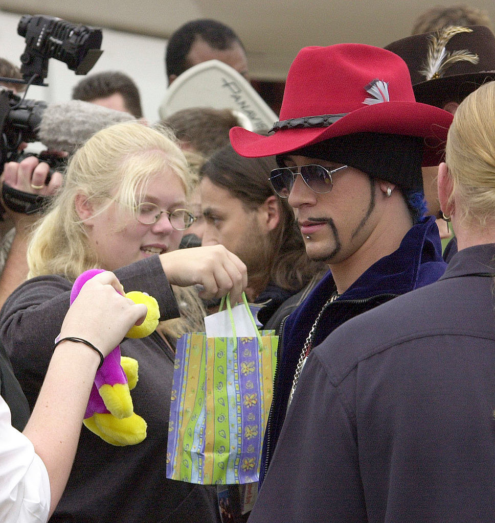 a girl giving aj from backstreet boys a gift