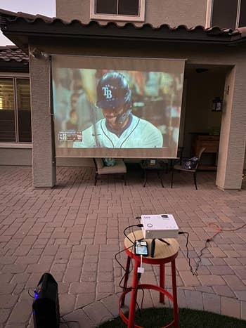 a reviewer's image of the projector showing a baseball game outside
