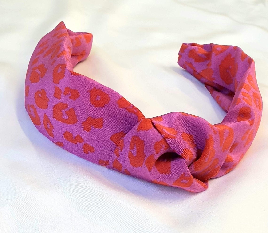 The 100% silk pink and orange leopard print knot headband