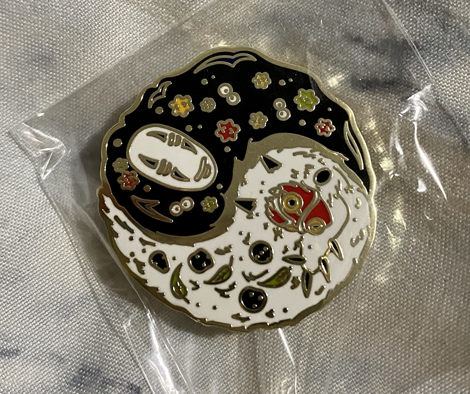 the round pin, with the black side featuring No Face and soot sprites and the white side featuring the Princess Mononoke mask and Kodama faces