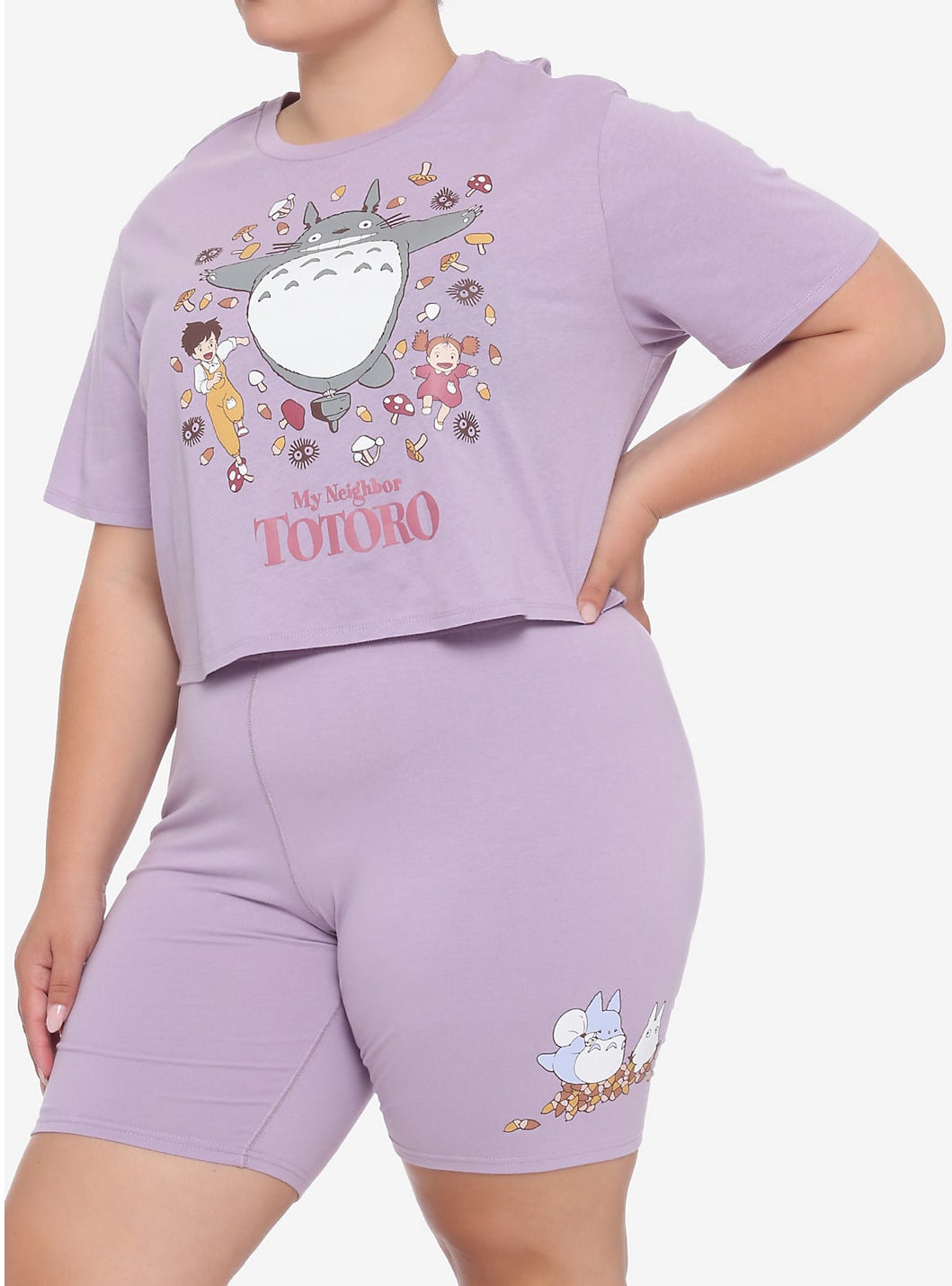model in the purple crop top and bike shorts with graphics of Totoro characters