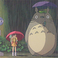 Satsuki Kusakabe and Totoro standing in the rain with umbrellas