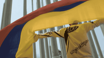 Person holding up Colombian flag. 