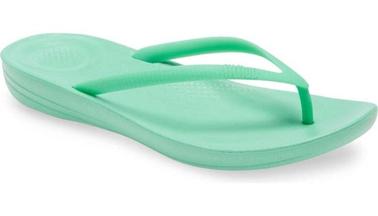the flip flops in mint green with an arched sole