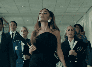 Ariana Grande walking with businesspeople looking like a complete boss