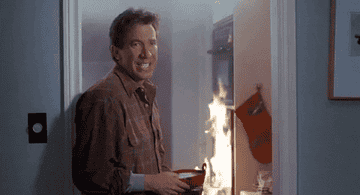 Tim Allen blowing out an oven fire with a fire extinguisher 