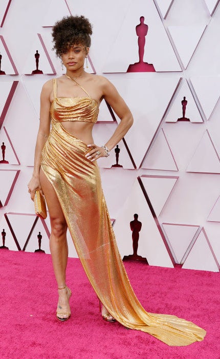 Andra wore a gold metallic gown with cutouts and an updo