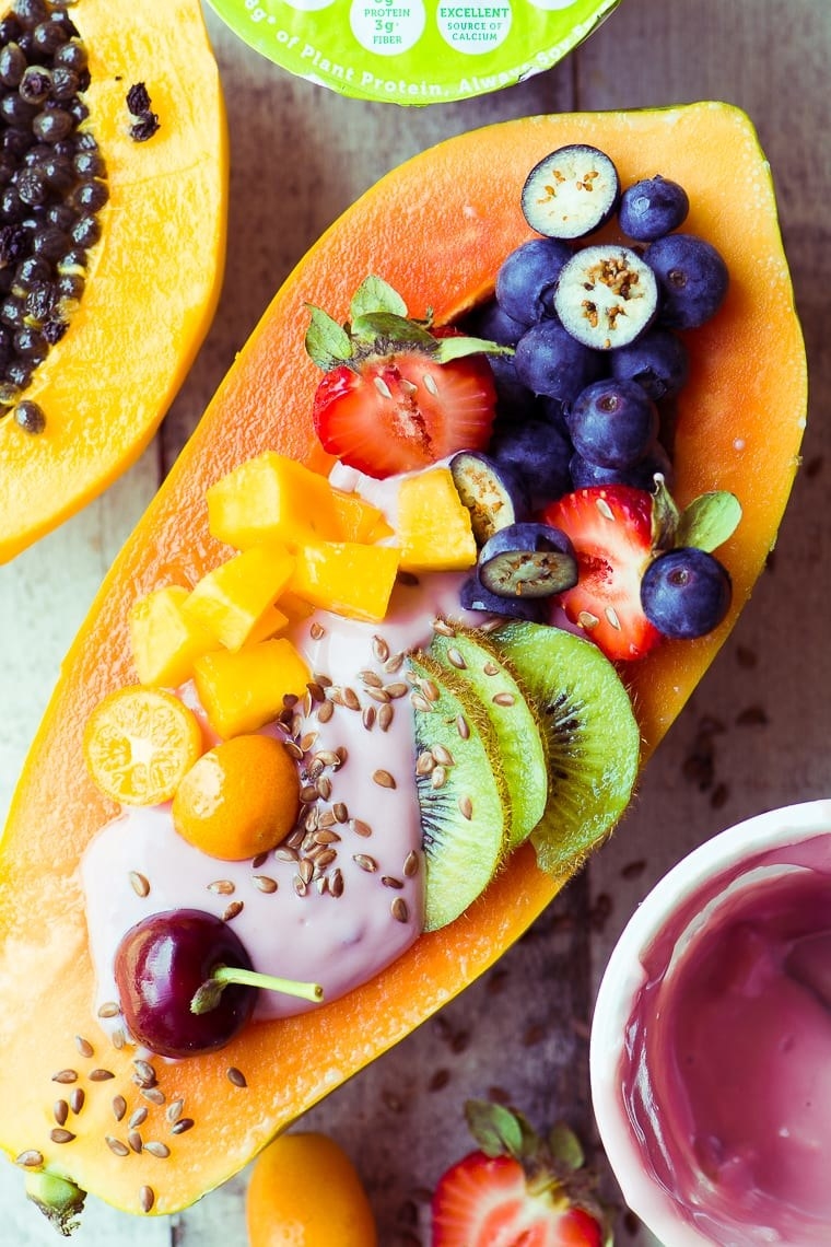 A papaya boat with yogurt and other fruits.