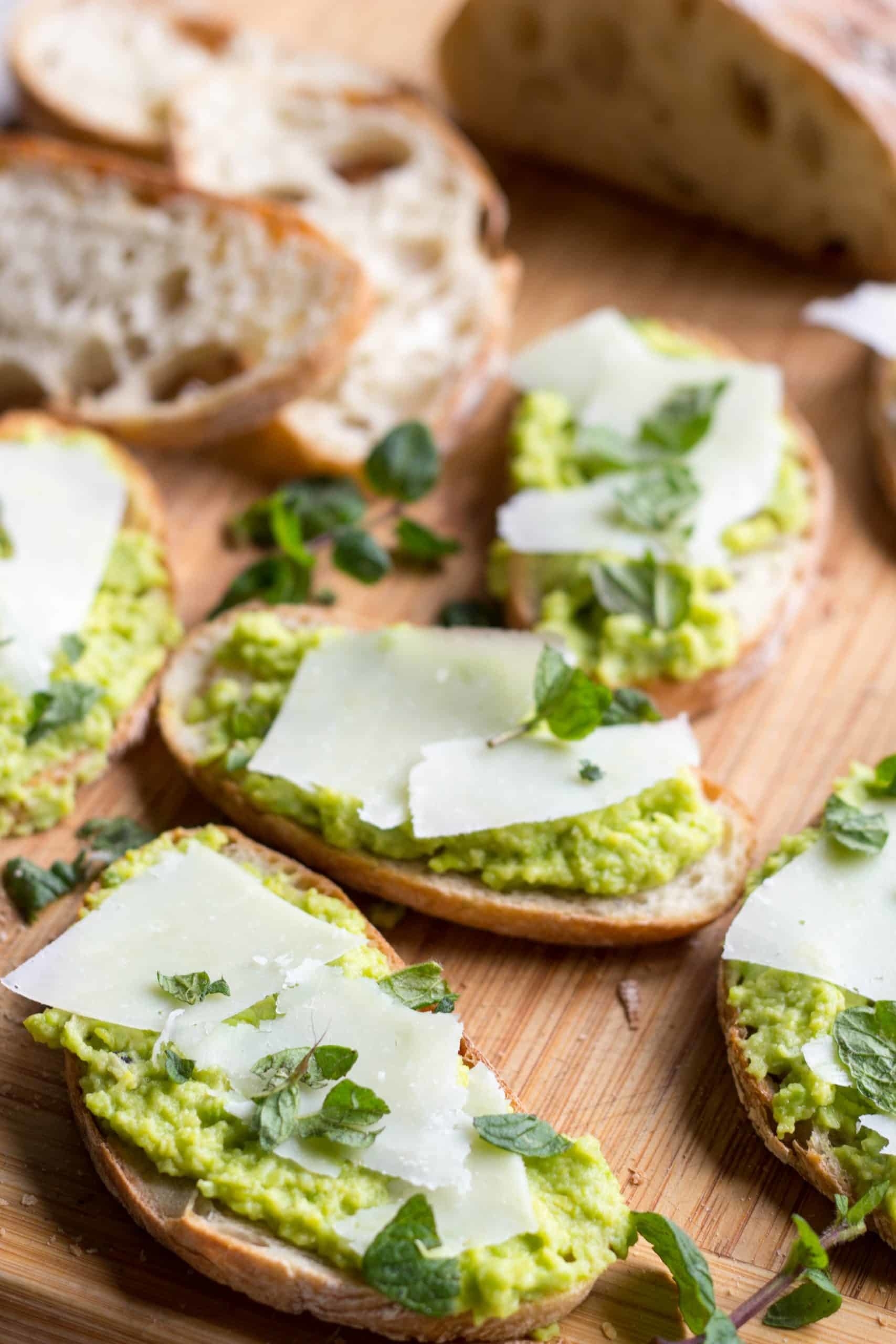 Fava bean toasts with shaved cheese and mint.