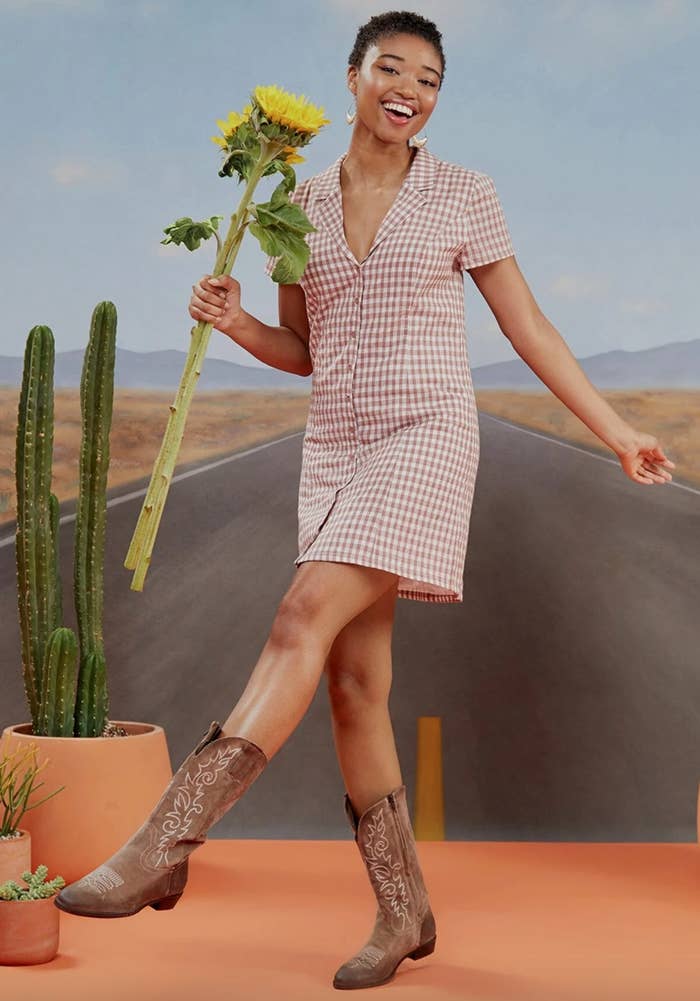 The daytime shirt dress in brown/ white being worn by a model in cowboy boots