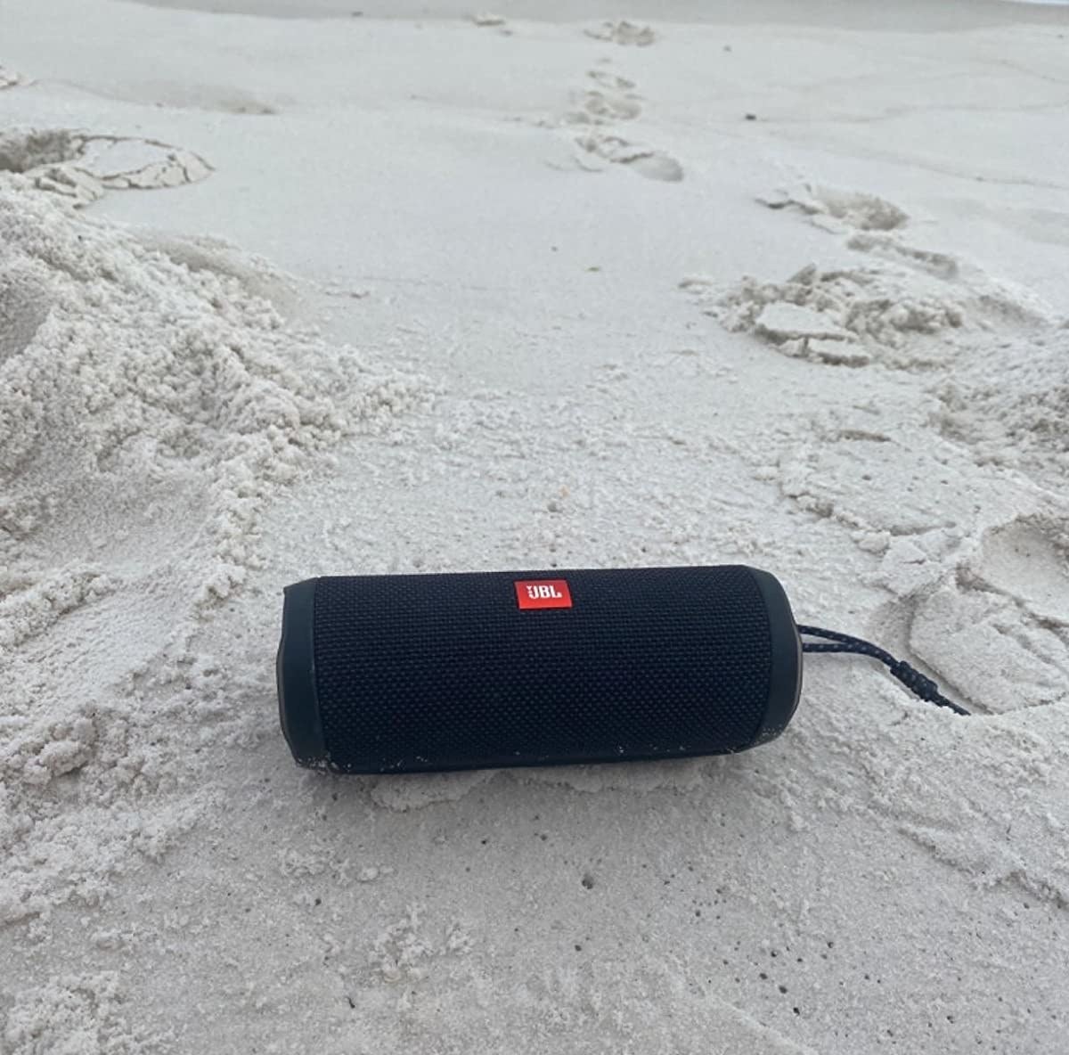 a tube-like speaker at the beach