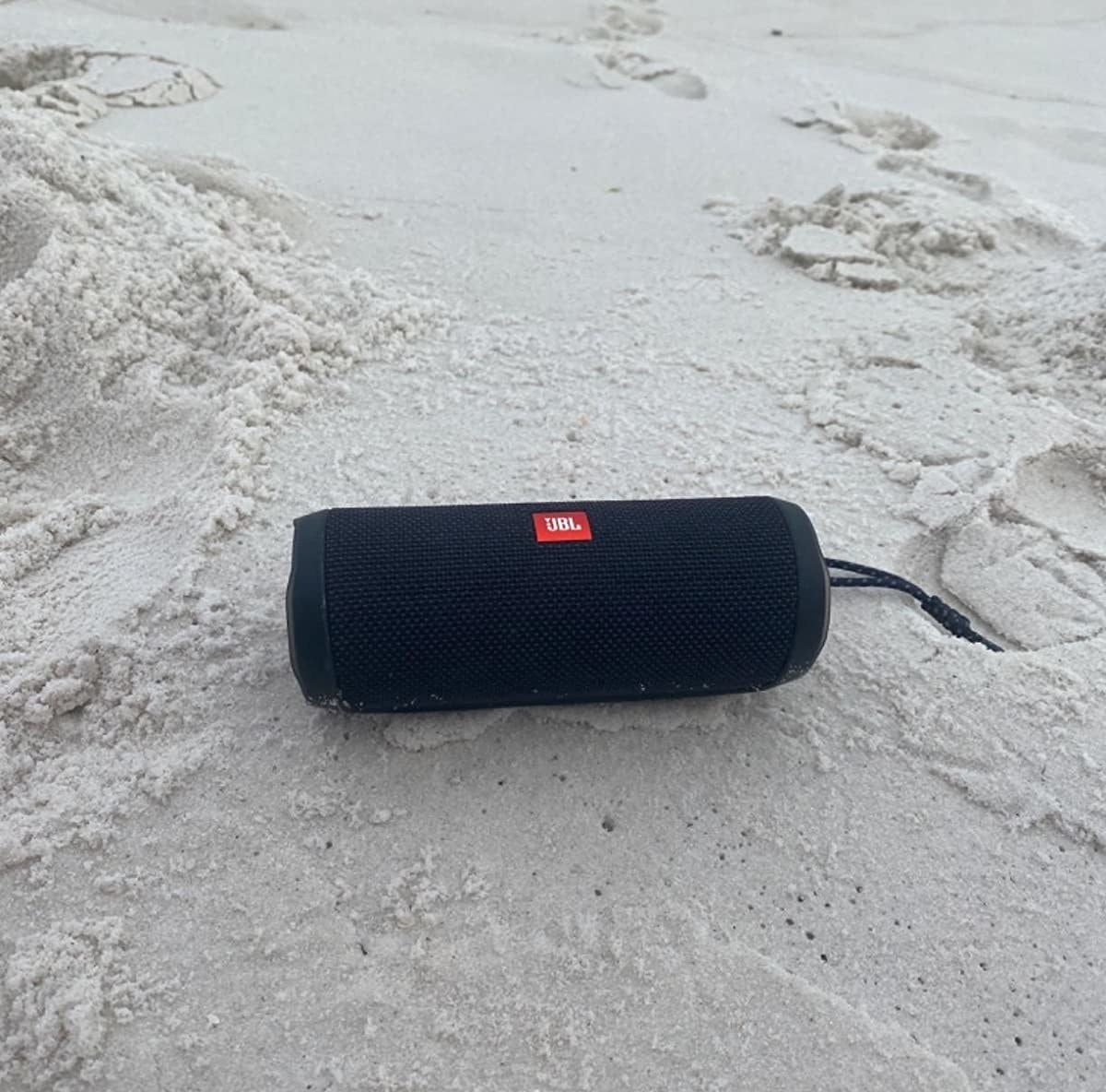 a tube-like speaker at the beach