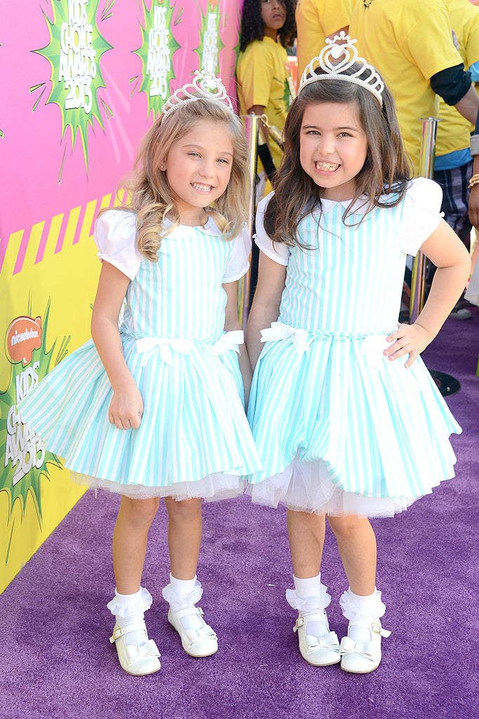The girls posing at the kids choice awards in matching dresses and tiaras