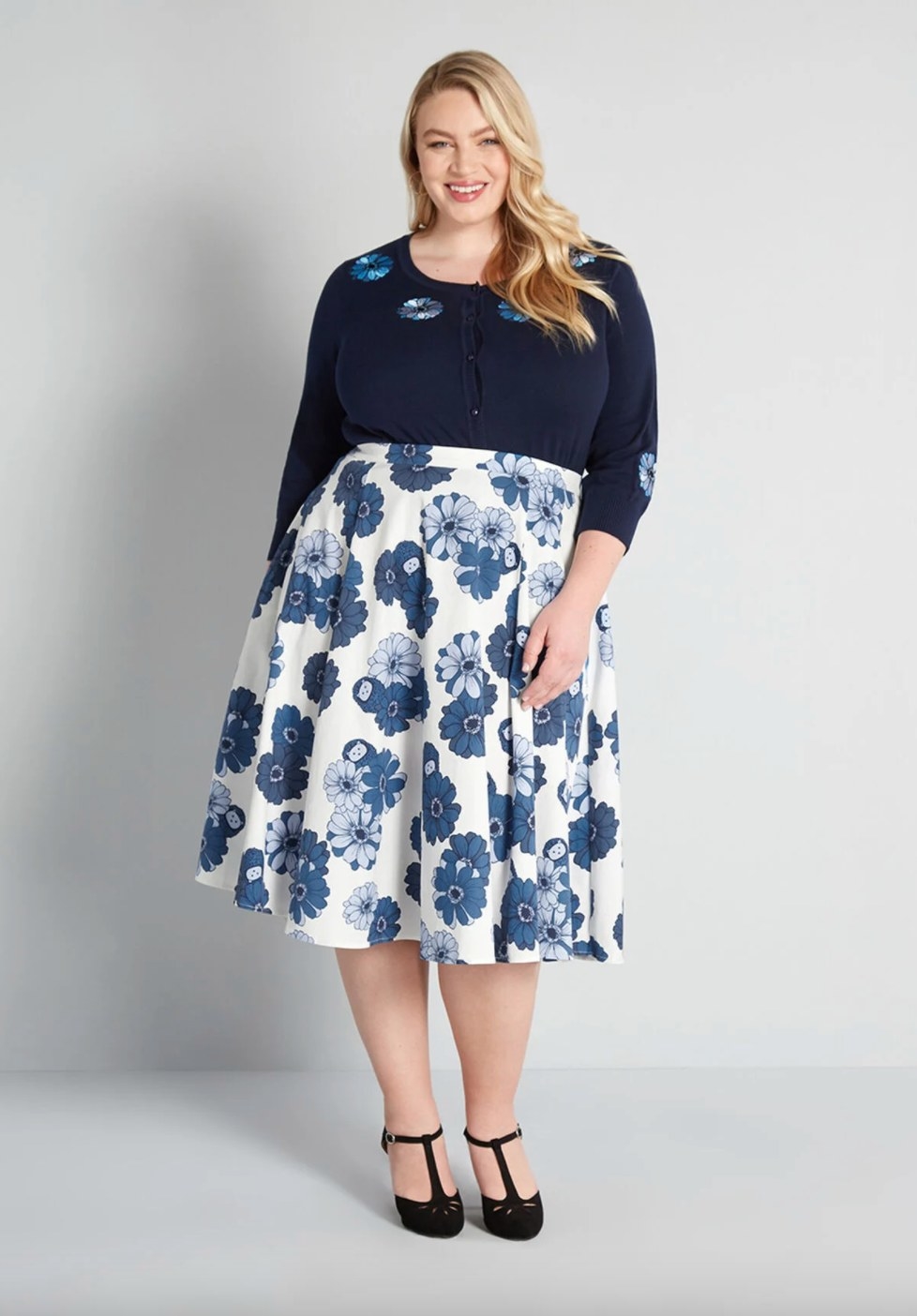 Model wearing a midi skirt with white and blue flowers