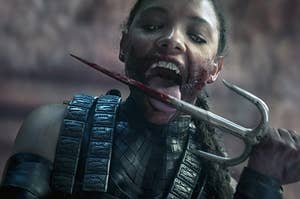 Mileena licking blood off a knife in Mortan Kombat