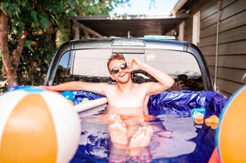Person sitting in a pool made from the back of a truck 