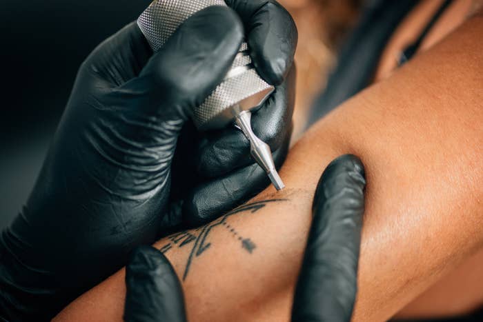 a tattoo being placed on an arm