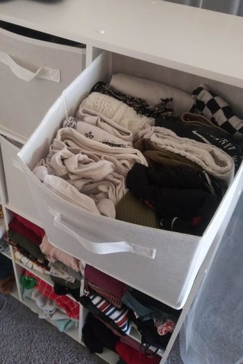 a reviewer photo of a cube bin filled with clothes 