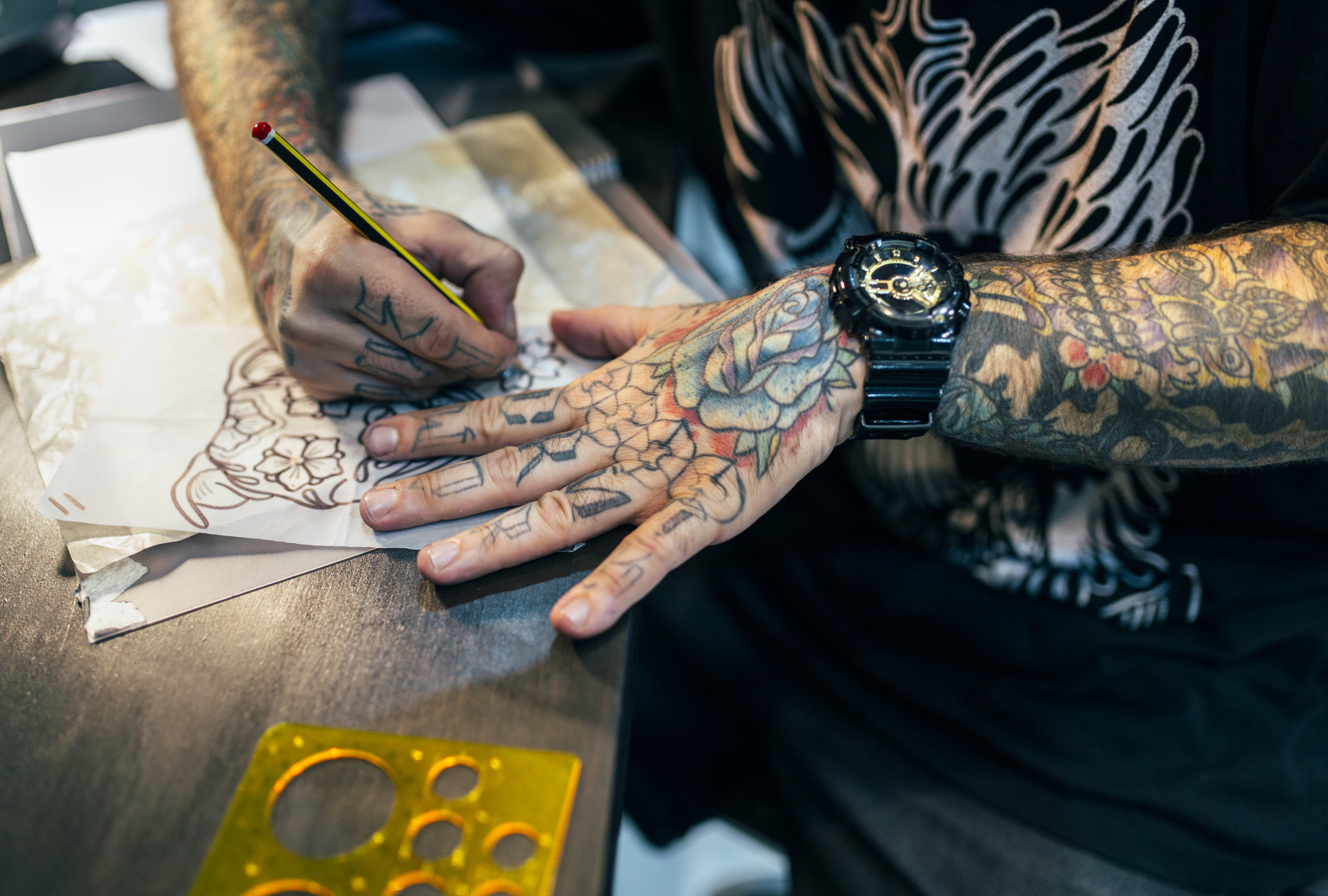 a tattoo artist doing a sketch