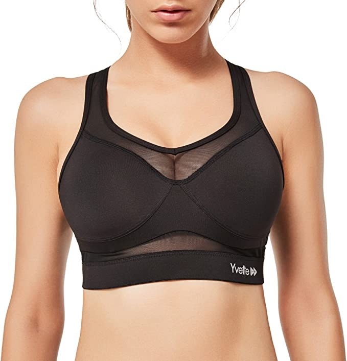a model wearing the black yvette mesh sports bra