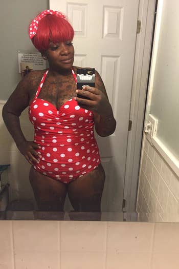 reviewer wearing the suit in red and white polka dot