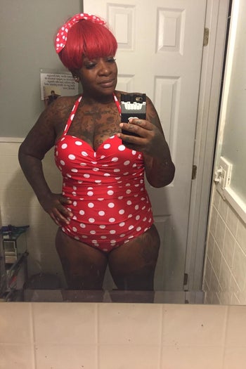 reviewer wearing the suit in red and white polka dot