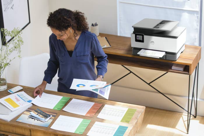 A woman organizing colored prints
