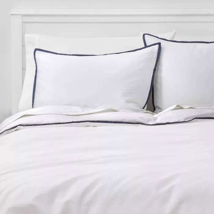 The white comforter and sham set with a navy border