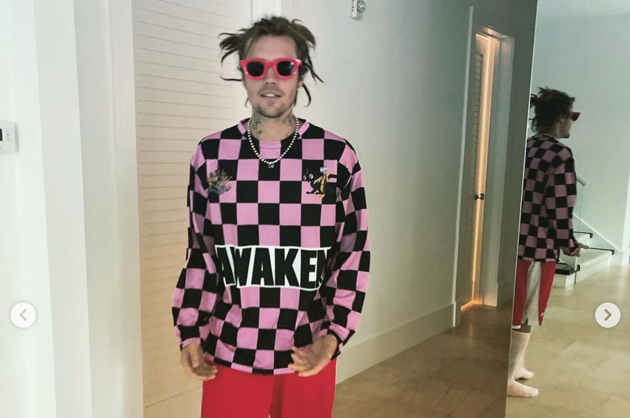 Justin Bieber standing in a room while wearing dreadlocks