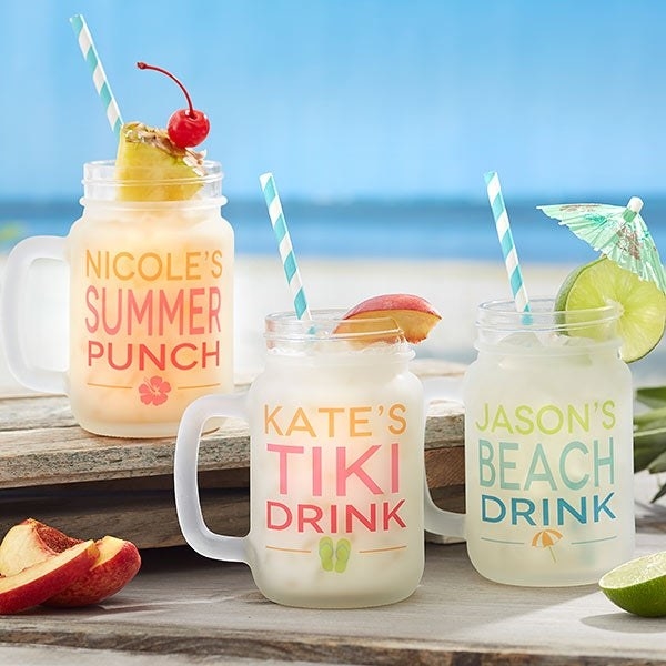 mason jars with handles that have personalized text like &quot;Kate&#x27;s Tiki Drink&quot; in different colors and logos 