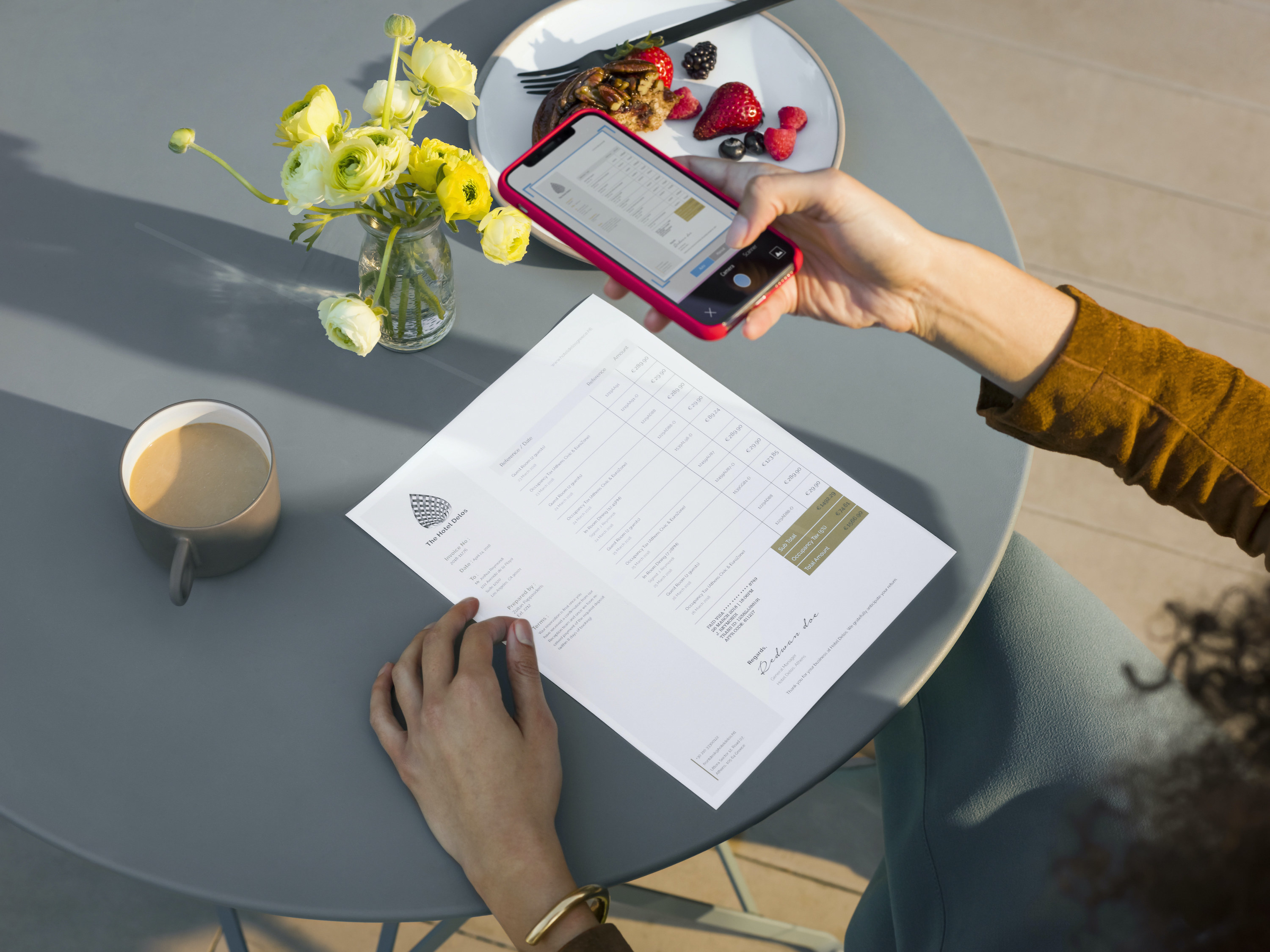 A person taking a picture of their document