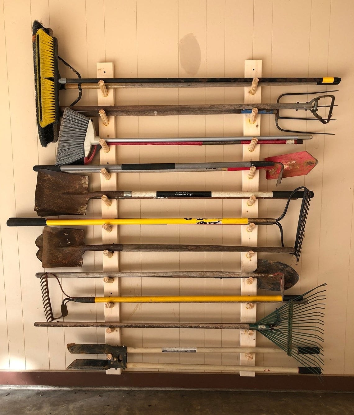 the wood rack holding about 11 yard tools 