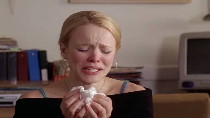 Woman crying into a tissue