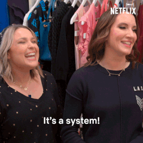 gif from &quot;the home edit&quot; of Clea Shearer, Joanna Teplin, and reese witherspoon saying &quot;it&#x27;s a system!&quot; 